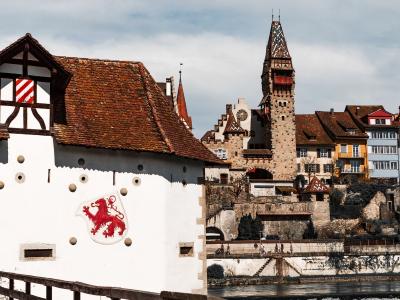 Charming view of Bremgarten castle and historic buildings by the River Reuss in Switzerland.