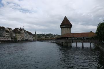 Picturesque view of Chapel Bridge and Water Tower in Lucerne, Switzerland with historic architecture.