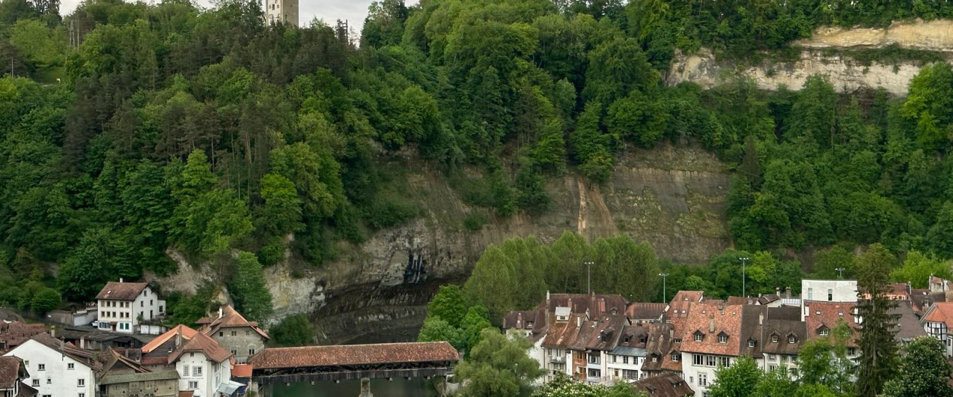 Explore the medieval charm of Fribourg, Switzerland, overlooking the scenic Saane River and historic buildings.