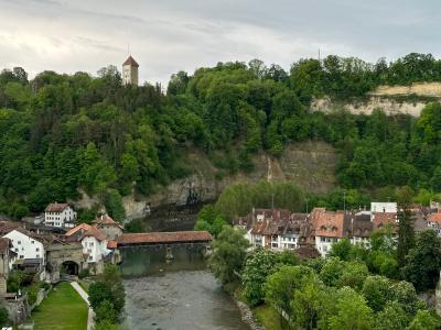 Explore the medieval charm of Fribourg, Switzerland, overlooking the scenic Saane River and historic buildings.